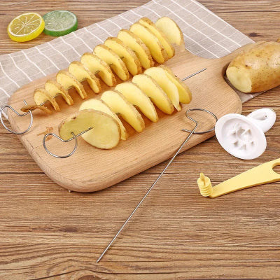 Sliced spiral potato on wooden board with spiral cutter, BBQ skewer, and kitchen accessories